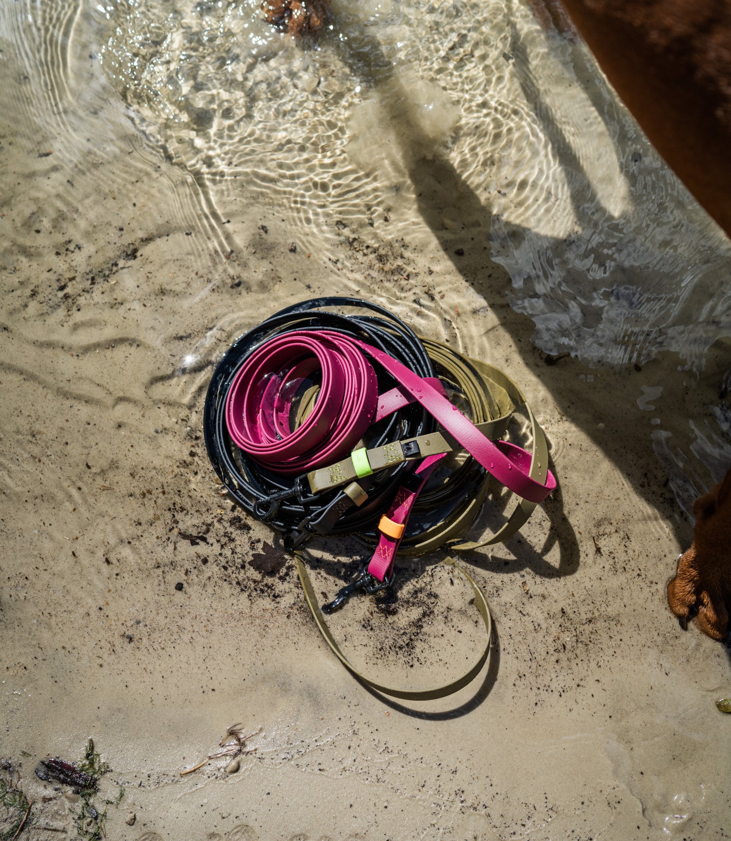 stack of Ipanema long leads on riverbank, half covered with water