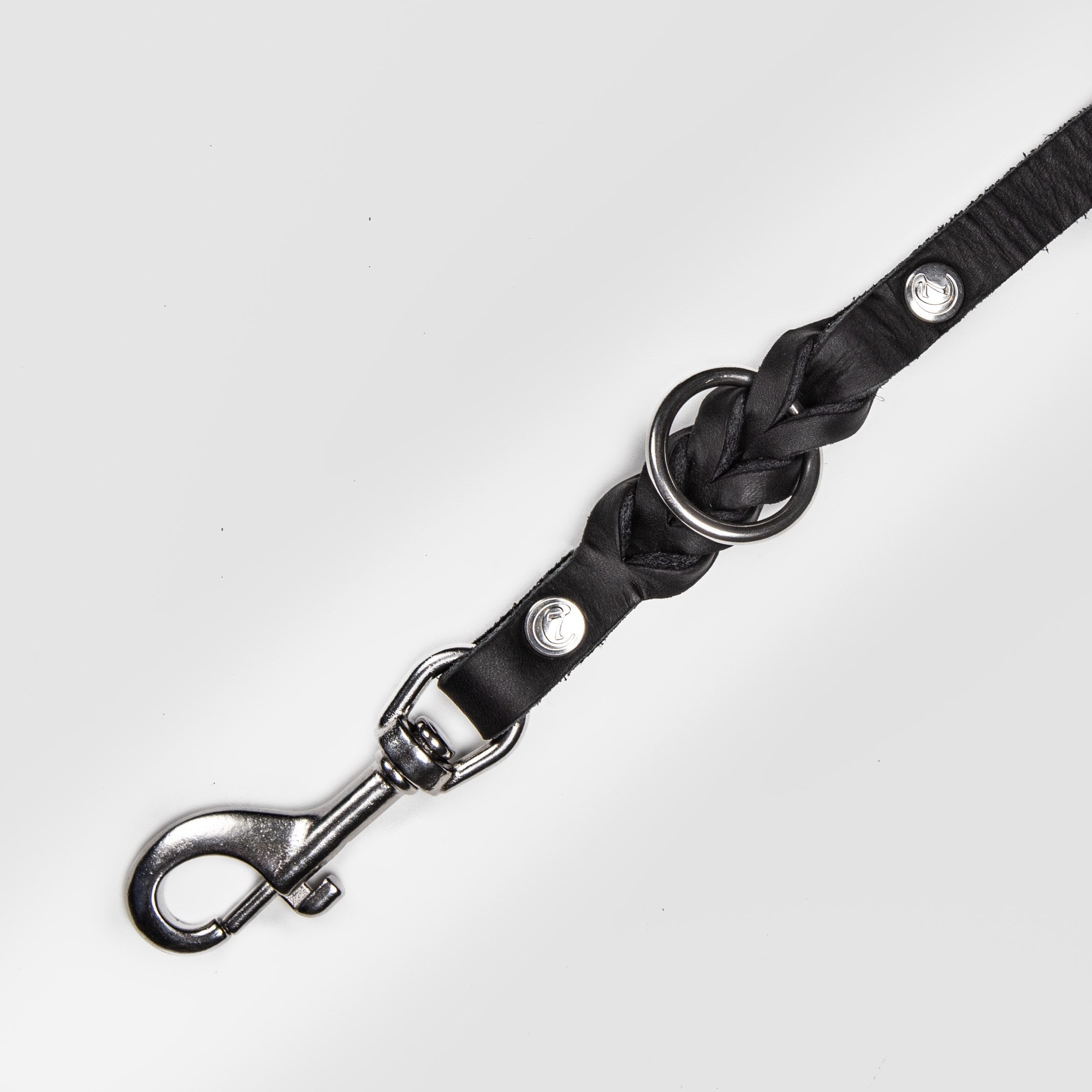 Details silver carabiner of a black leather dog leash