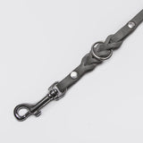 Grey dog leash with braided leather details and silver closure