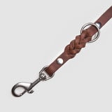 Details silver carabiner of a dark brown leather leash for dogs