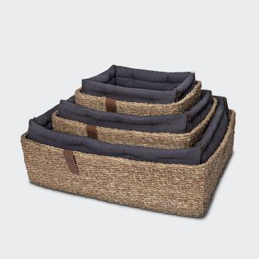 Dog basket made from natural seaweed with aubergine cushions